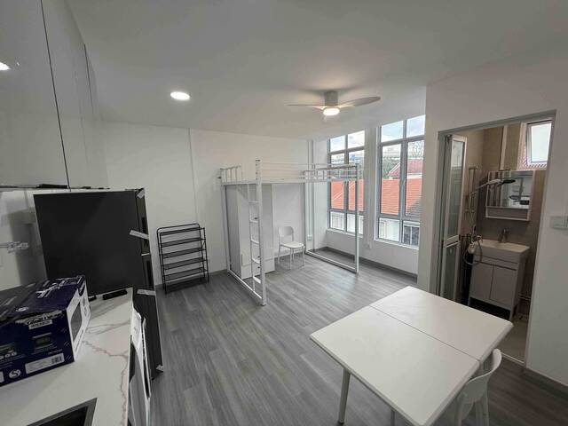 Common room with high ceiling and huge windows