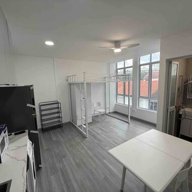 Common room with high ceiling and huge windows